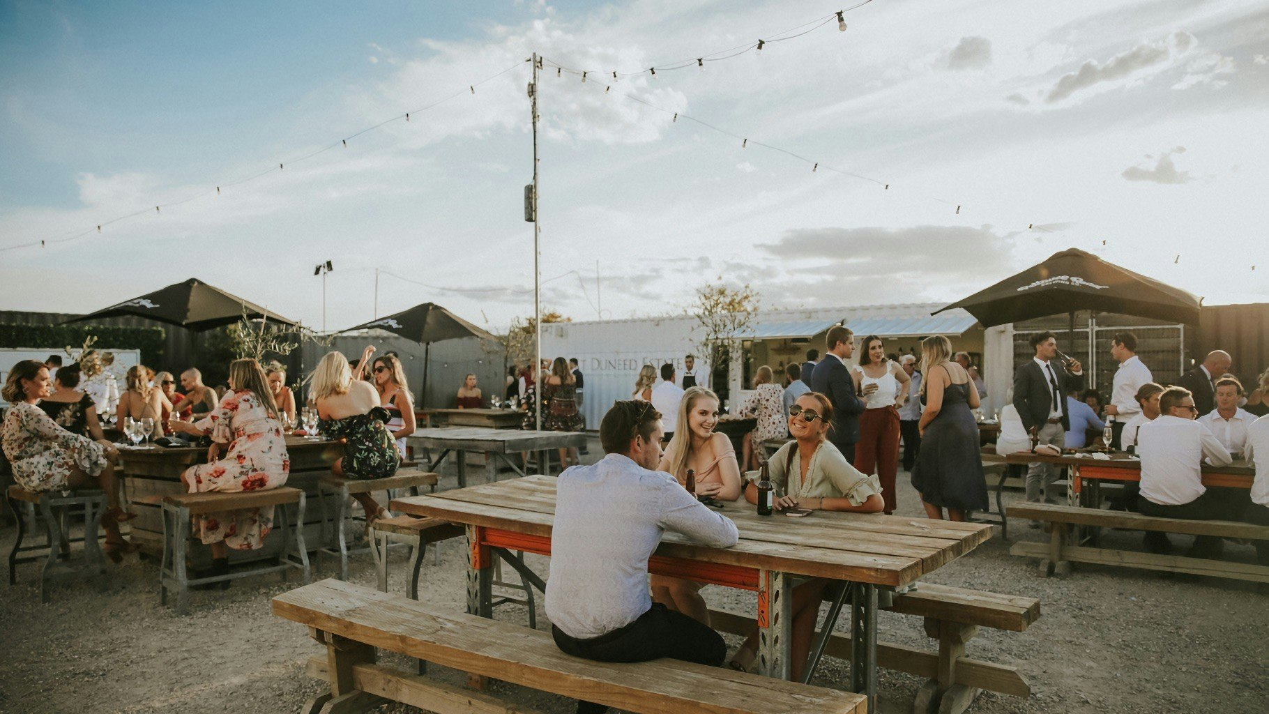 Seated wedding guests in an outdoor space.